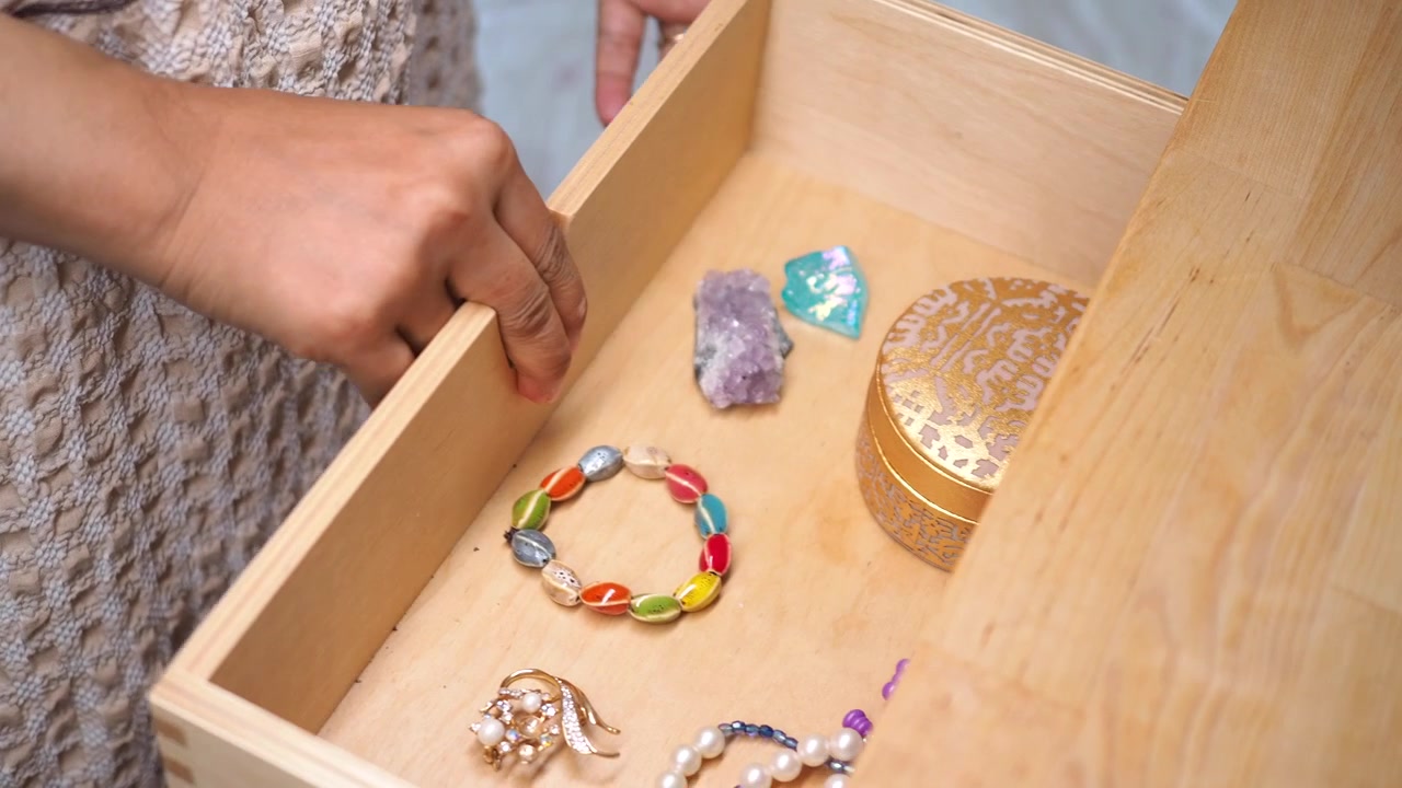 Woman Opening Wooden Drawer to Retrieve Decorative Jewelry Box