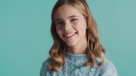 teenage caucasian girl smiling in front of the camera.