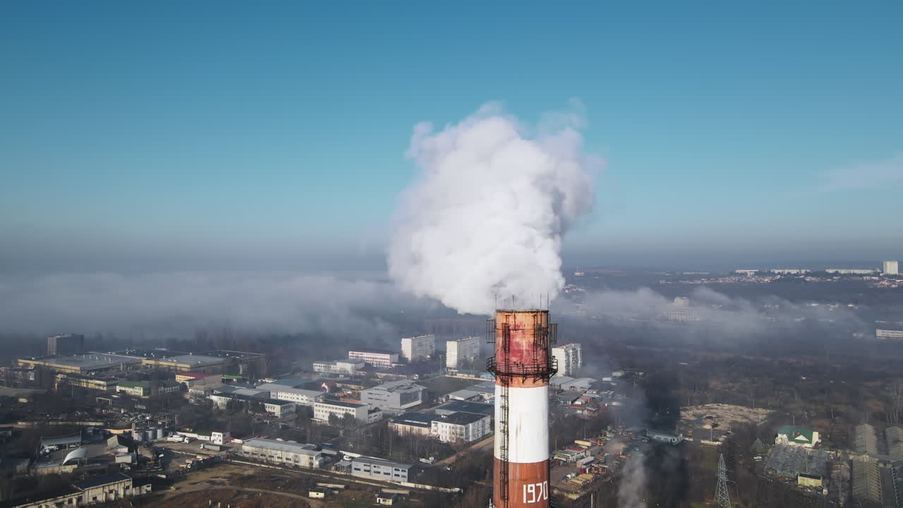 Aerial drone view of Chisinau. Thermal station with smoke coming out of the tube. Buildings, roads. Fog in the air. Moldova