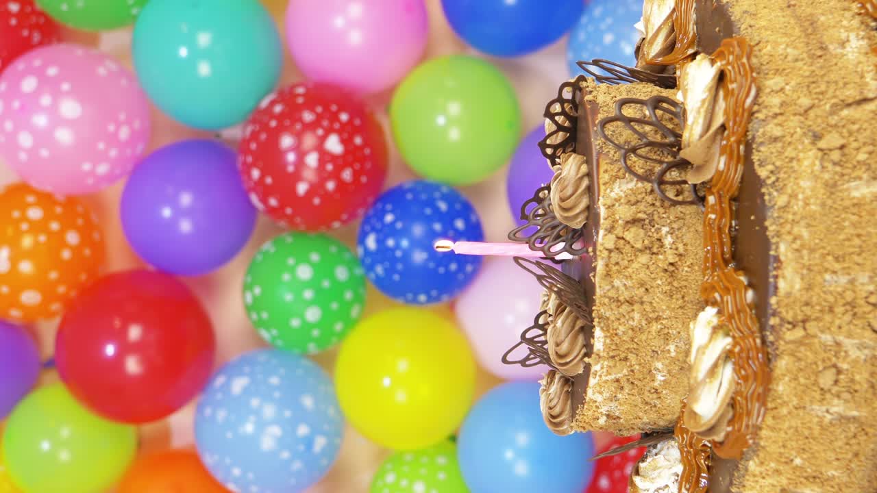 Chocolate cake with candle and balloons