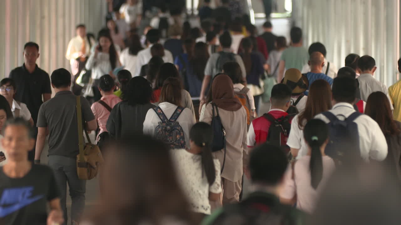 People walking passing through the subway going to the train station in Bangkok, Thailand - Medium shot