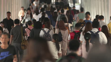 people walking passing through the subway going to the train station in bangkok, thailand - medium shot