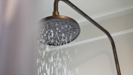 Close-up-of-water-running-from-a-shower-head