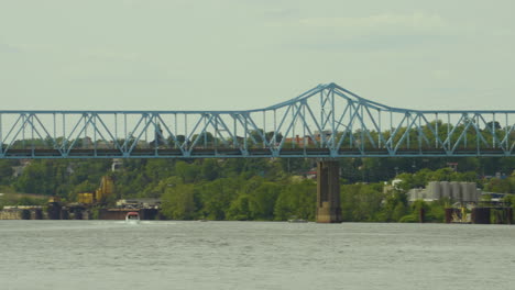 panning to the left on a long blue truss bridge in pennsylvania, monaca east rochester bridge on the ohio river