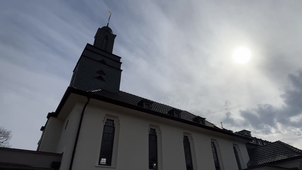 small white church with bell tower in good weather