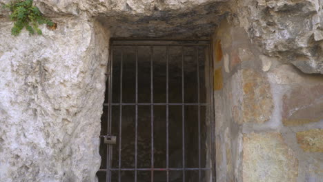 a castle jail view with the bars and lock