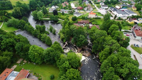 morrum village salmon fishing destnation with flowing river in blekinge, aerial orbit