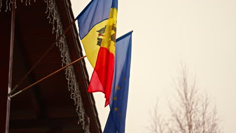 looking up into the flags of the republic of moldova and europe hanging on home ceiling outdoor