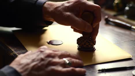 crafting tradition: the art of wax sealing on a letter with a detailed stamp, evoking nostalgia and the significance of handwritten communication