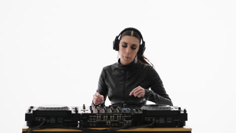 a female dj mixing music on a turntable