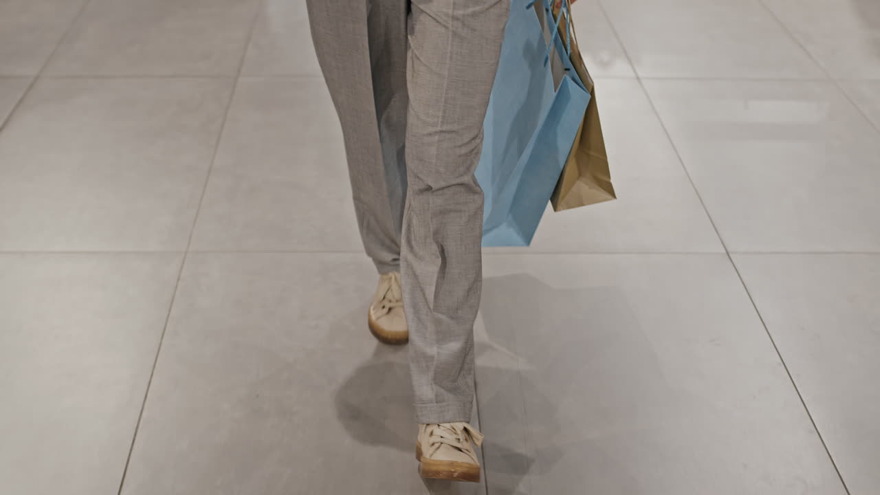 Legs Of Woman Walking Along Shopping Centre