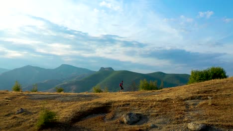 Hombre-Soltero-Caminando-Al-Aire-Libre-En-Un-Paisaje-Montañoso-épico,-Tiro-De-Seguimiento