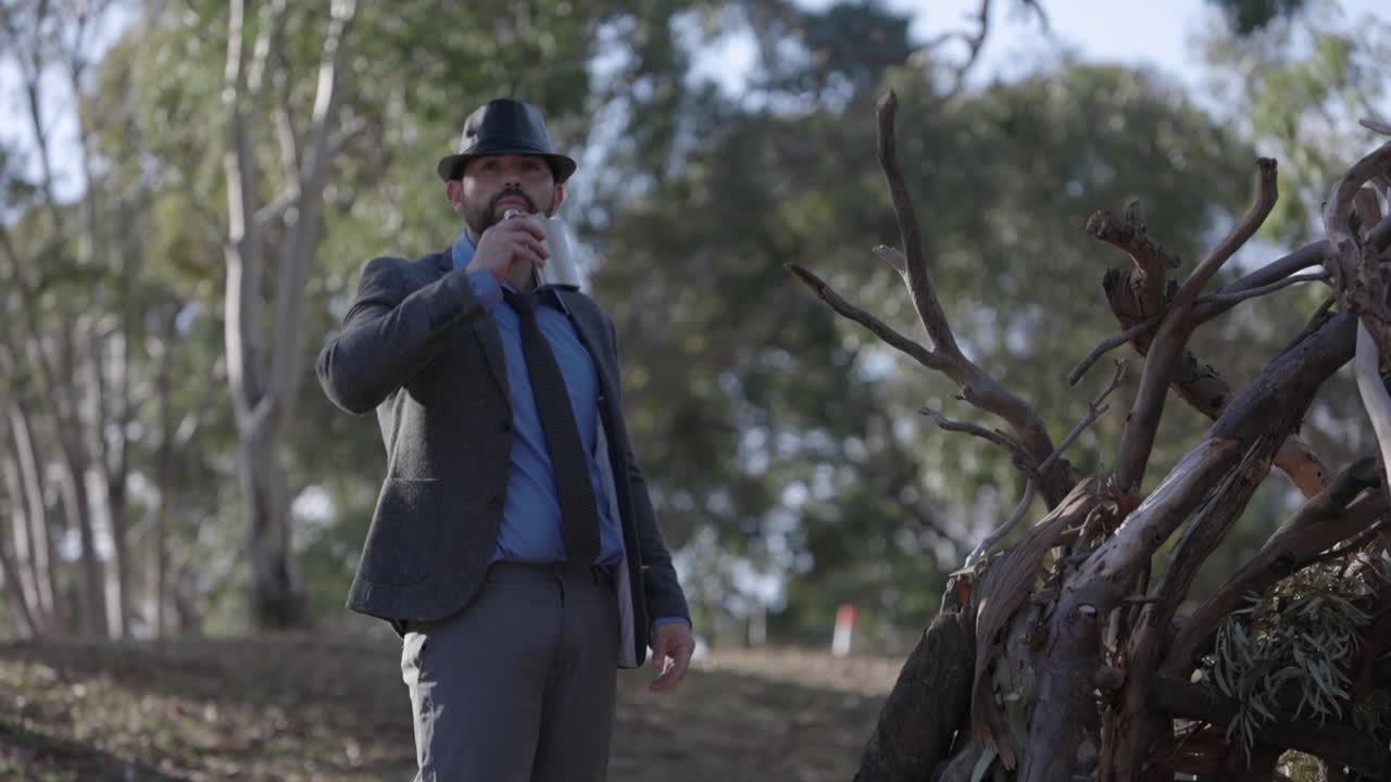 Man Police Detective In Jacket And Hat Outside Drinking Alcohol Flask Investigating Scene
