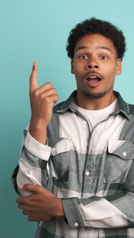 thoughtful young man with great idea in blue studio