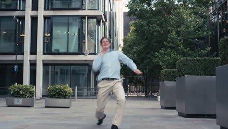 Contemporary-funky-caucasian-businessman-street-dancer-dancing-freestyle-in-the-city