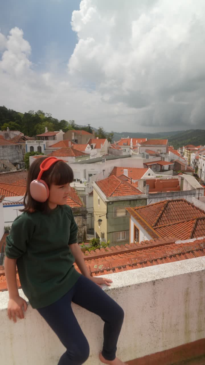 Girl Listening to Music on a Rooftop with City View
