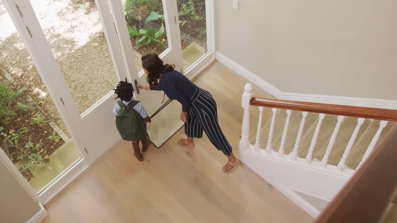 Mother saying goodbye to her son