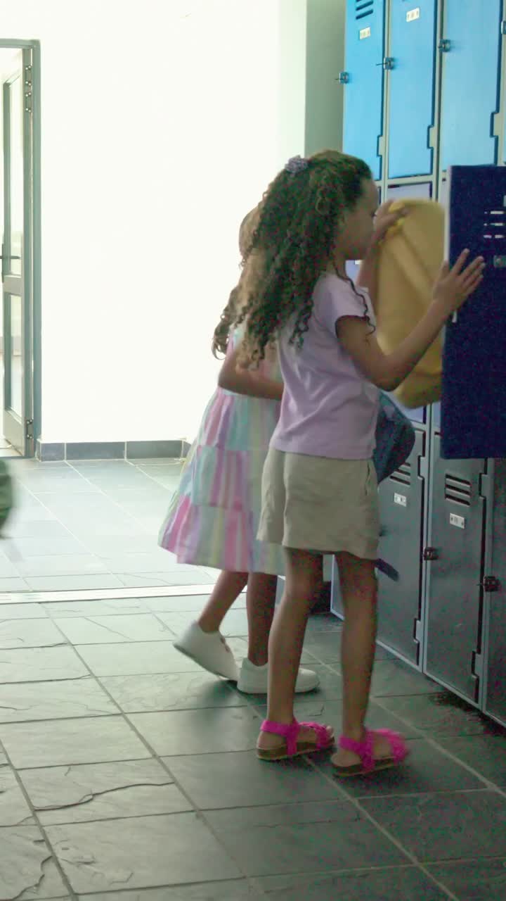 Vertical video: School door opening 2 girls pastel dress opening blue locker grabbing backpacks