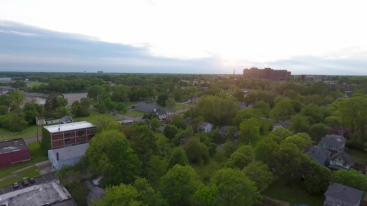 From above, Flint, Michigan at dusk in summer looks like a beautiful place with craftsman houses and leafy green trees, and, it is, unless you drink the water.