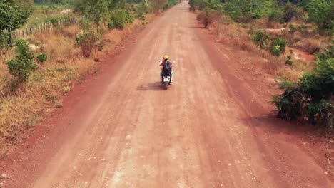 motorbike travelling down a dusty road