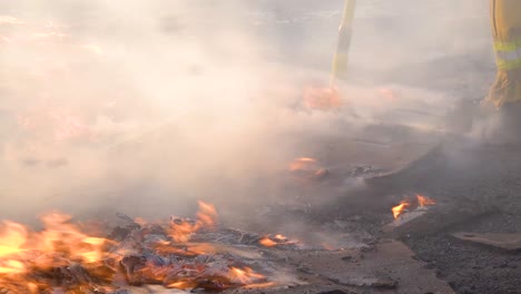 pallets and boxes burn on the ground while firefighters battle burning structures during the easy fire wildfire disaster in the hills near simi valley southern california 2