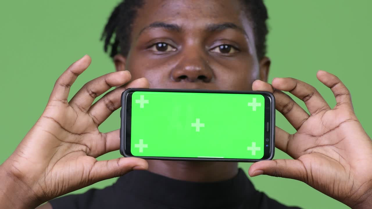 Young beautiful African businesswoman showing phone