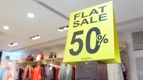 flat 50% off sale sign in a store