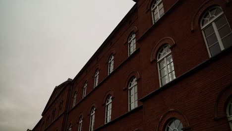 old brick building with large windows in germany with an overcast sky