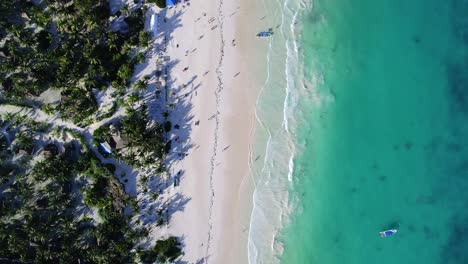 beautiful-caribbean-beach,-relaxing-caribbean-sunset,-turquoise-sea,-white-sand,-people-walking-on-the-beach