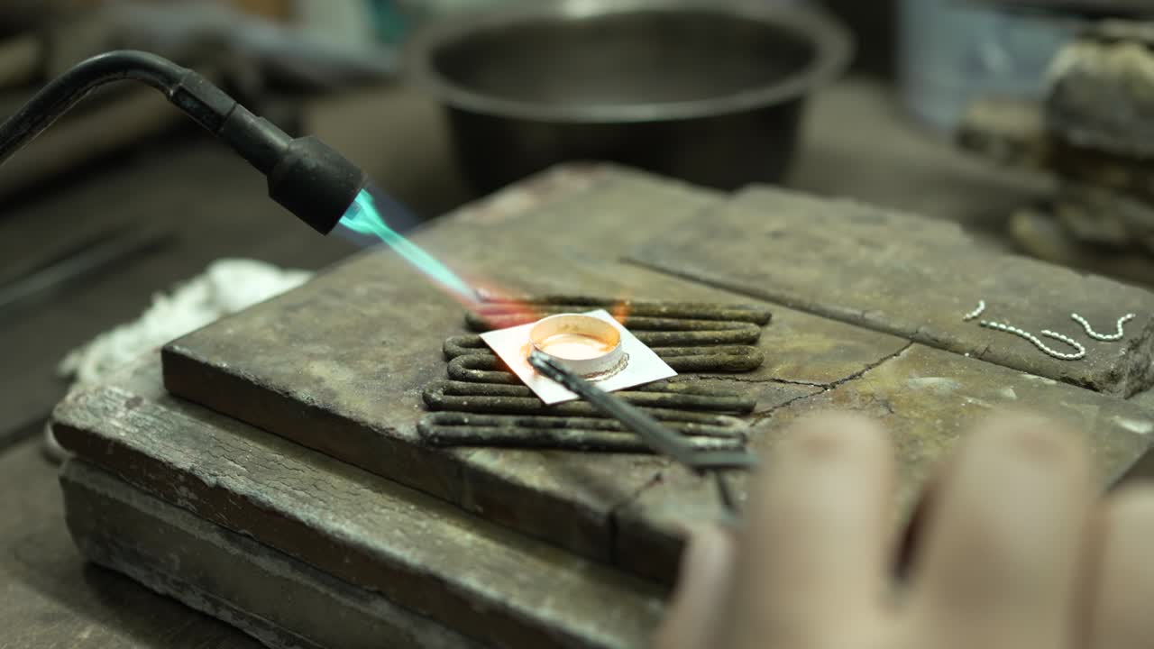 Jeweler at work in jewelry. Desktop for craft jewelry making with professional tools. Close up view of tools. Thailand.