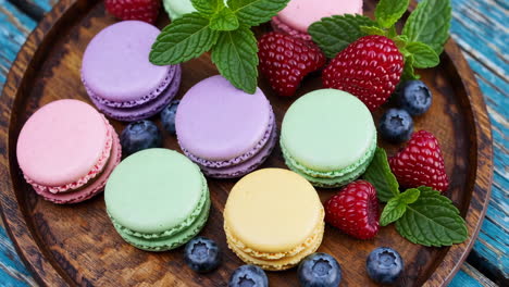 colorful macarons with berries and mint