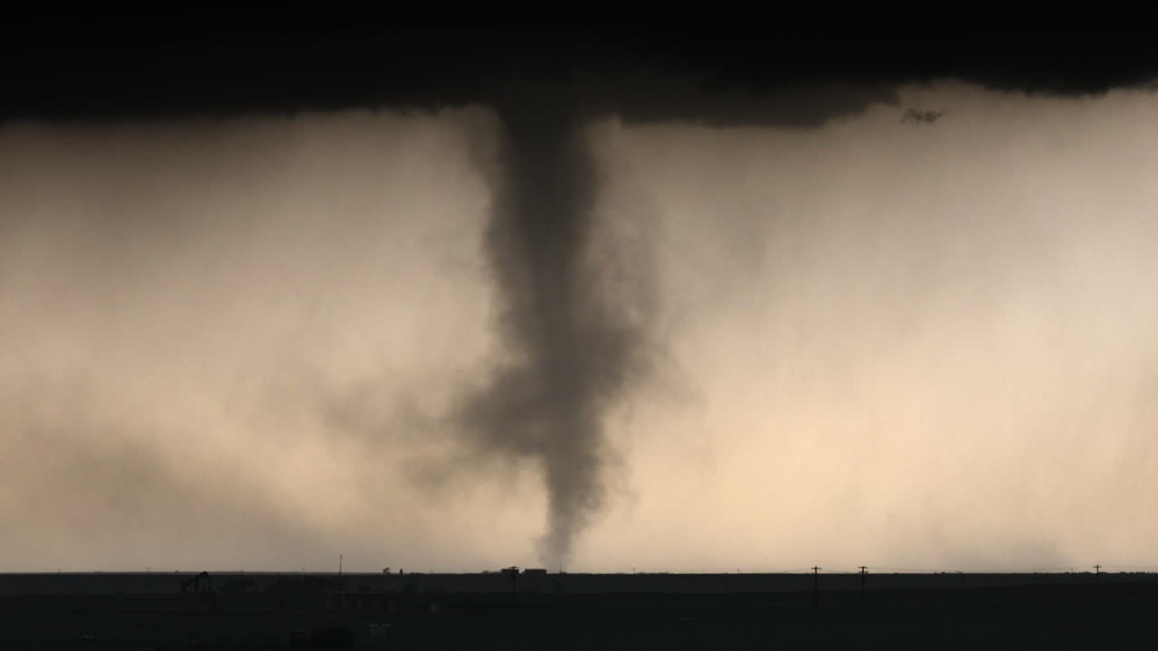 Scary Tornado Spinning Below Dark Storm Clouds With Heavy Rain And Hail Falling