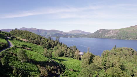 drone shot flying towards derwent water on a sunny day, lake district, cumbria, uk