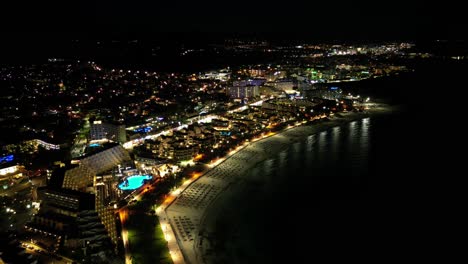 Sa-Coma-Beach-With-Sparkling-Lights-At-Night-In-Balearic-Islands,-Spain