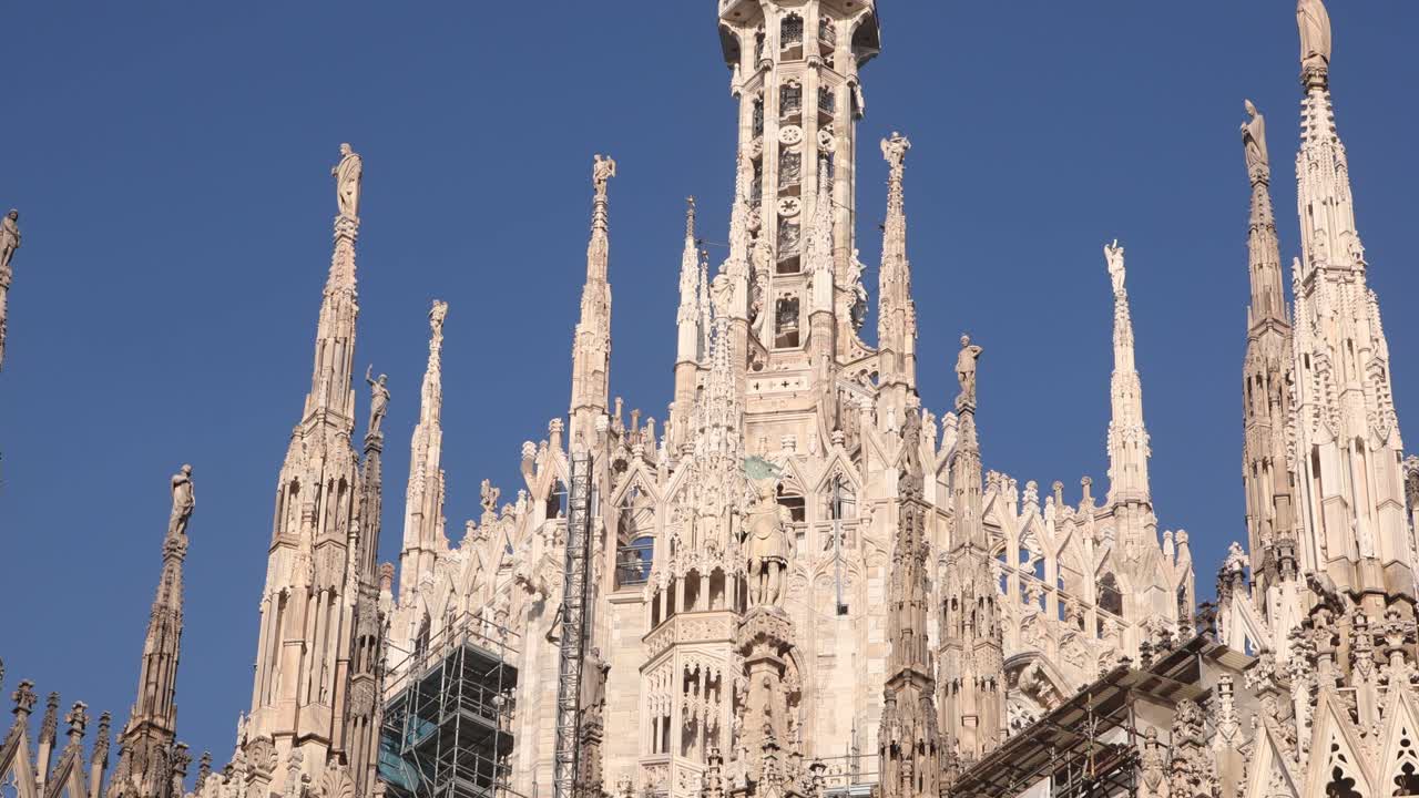 Upward Pan of Milan Cathedral's Intricate Gothic Spires and Statues