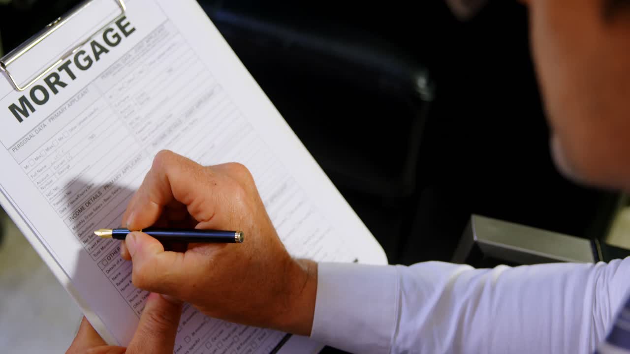 asesor comprobando el formulario de hipoteca en la oficina 4k