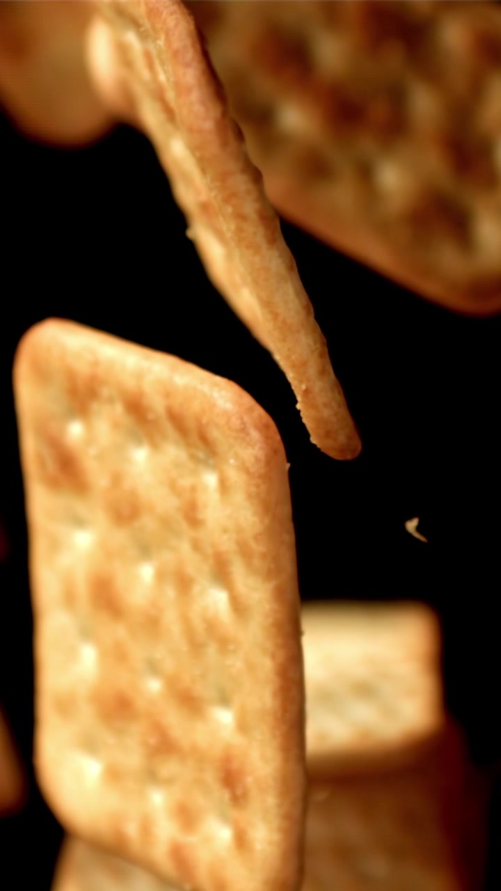 Golden Square Crackers Falling in Slow Motion
