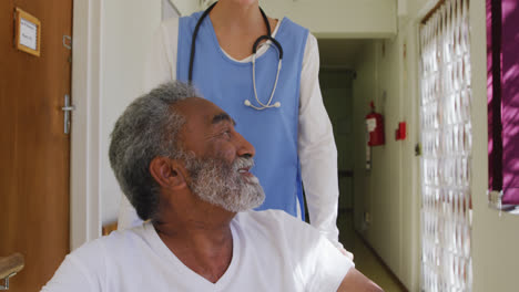 nurse helping a senior man in retirement house