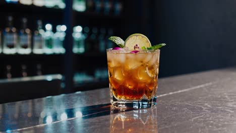exquisite mai tai cocktail, garnished with mint, lime, and a flower, sits on a bar counter, its reflection shimmering on the polished surface, with a backdrop of illuminated liquor bottles