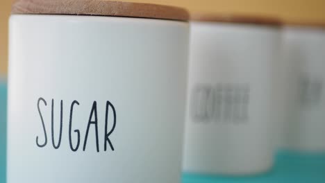 white ceramic canisters for sugar, coffee, and tea