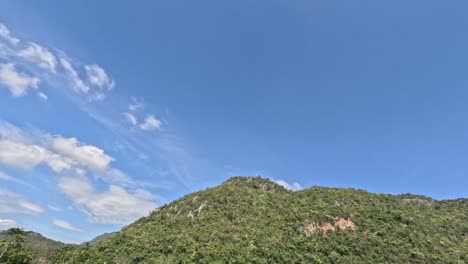 time-lapse of clouds moving over a mountain.