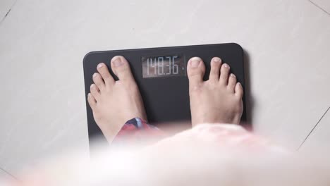 person weighing themselves