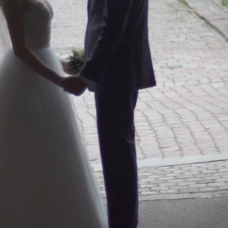 bride and groom holding hands