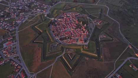 Top-down-view-of-medieval-fortress-Almeida-Portugal-during-sunrise,-aerial