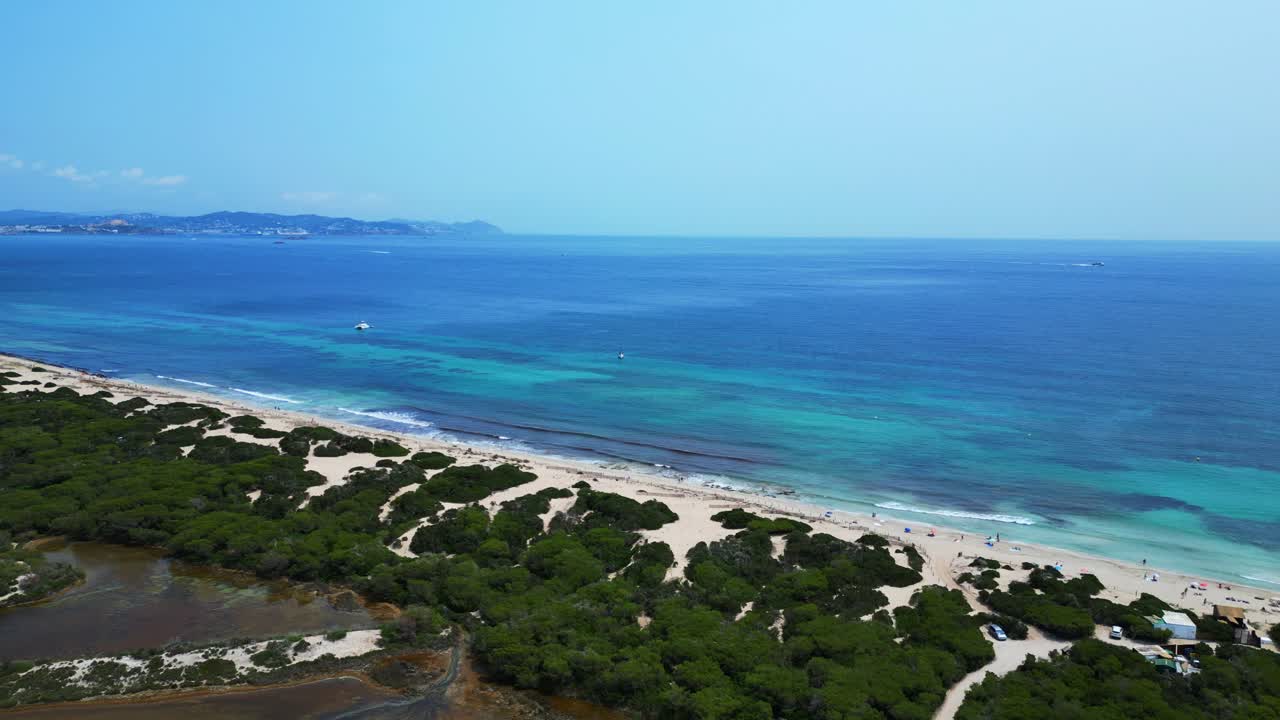 stunning beauty of Cavallet beach, with its turquoise waters and white sand, in Ibiza, Spain. drone shot footage from above
drone