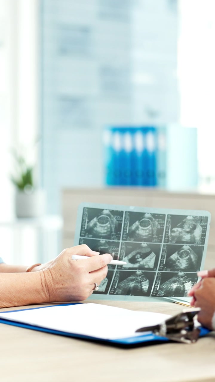 Doctor Explaining Ultrasound Scan Results to Patient in Clinic