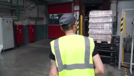 worker walking through industrial warehouse