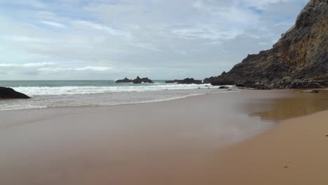 Atlantic-Ocean-Waves-Crash-on-Beach-near-Gruta-da-Adraga-Mountain