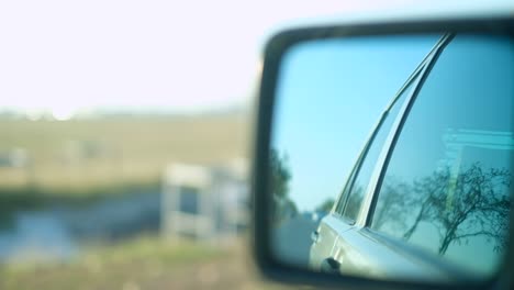 view of the sun at sunset in the rearview mirror of a vintage car 4k