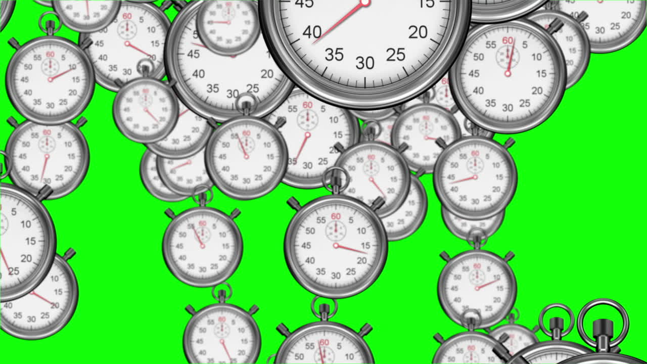Stopwatches falling on green background